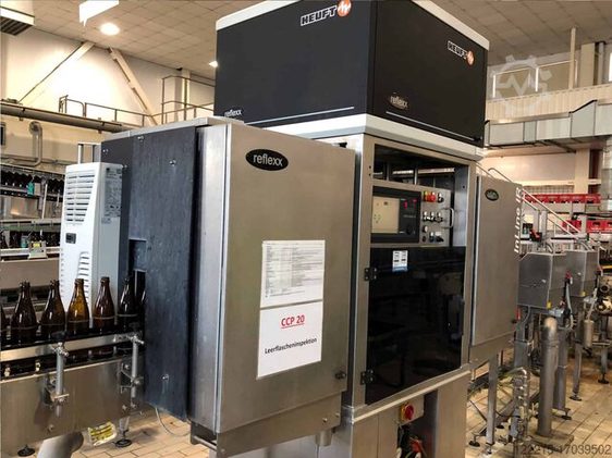 Automated empty bottle inspection machine on a bottling line